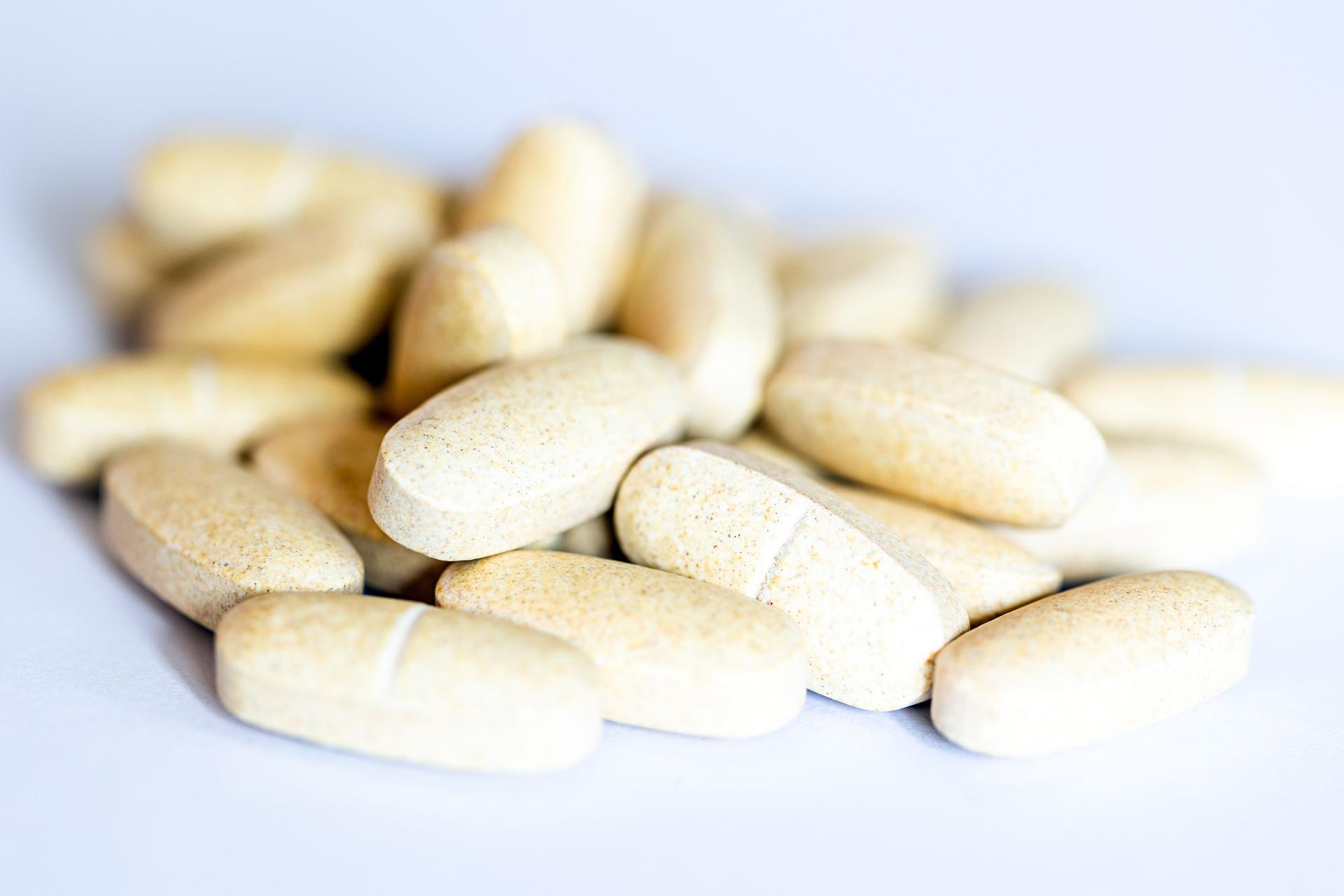 Natural Vitamin supplements on white background
